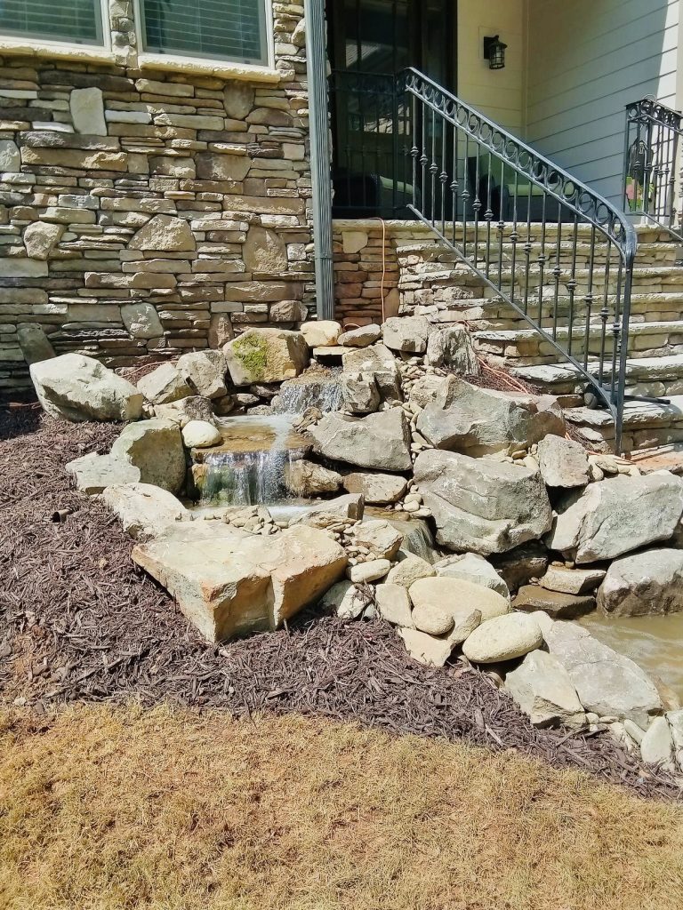 water features, water feature, pondless waterfall, water feature with stone, hardscaping, stone patio, stone walkway, flagstone, pavers