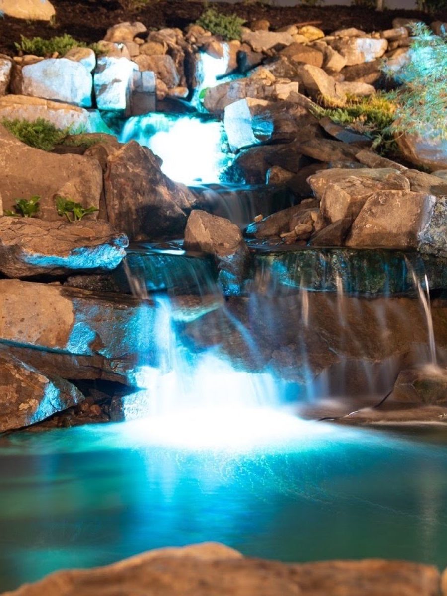 water feature at night, water features, water feature, water feature with stone, stone lighting, pond, pond with lights, pond with waterfall and light fixtures