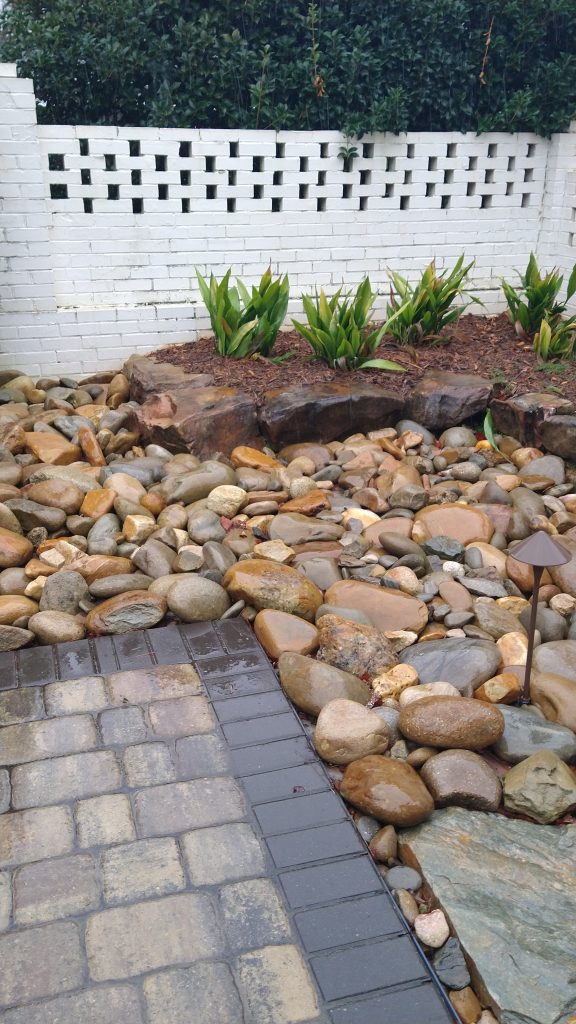 groups of rocks and stones bordering a stone patio